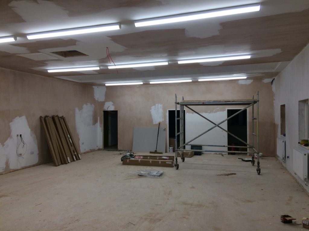 The main hall - now with electric lights and wall-mounted radiators.